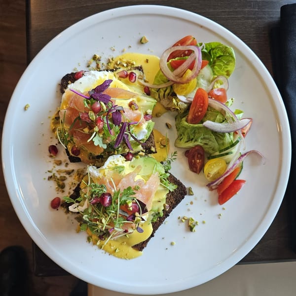 Rivage Oak Kitchen's avocado toast with salmon, poached eggs, pomegranate, and a side salad.
