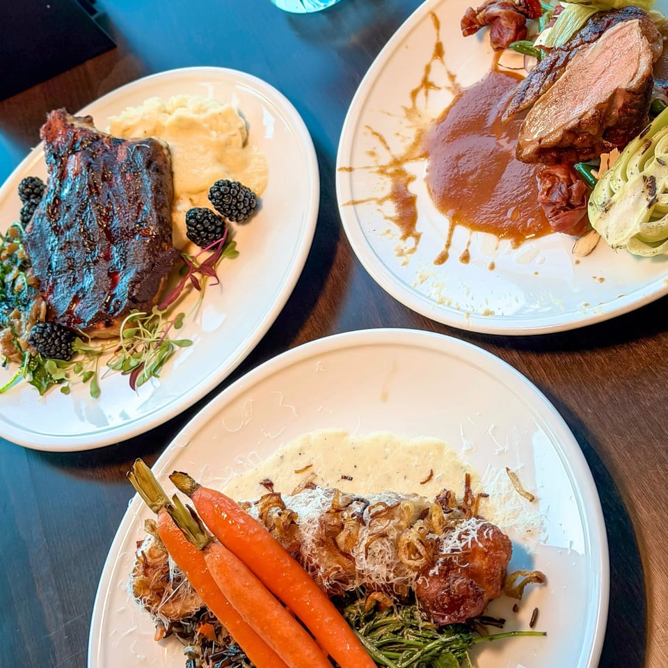 Three gourmet dishes on white plates, including ribs, sliced meat, and carrots with a creamy sauce.